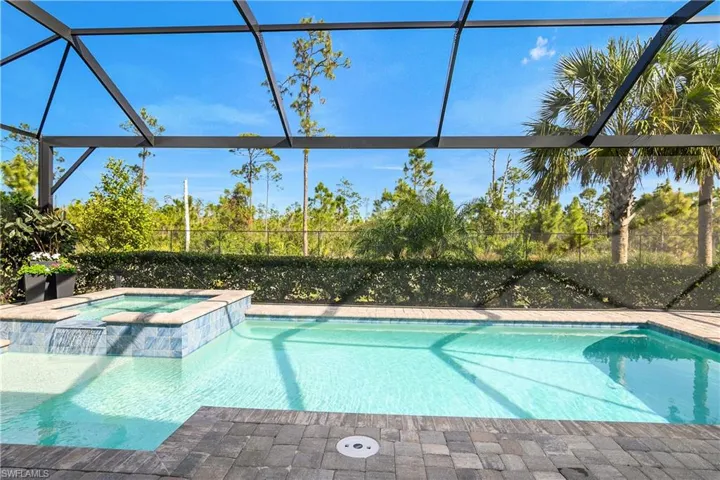 Relax and enjoy this gorgeous pool/spa which includes a sun shelf and panoramic screen for an unobstructed view of the beautiful preserve.