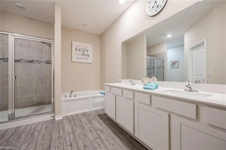Kitchen featuring light wood-style floors, white cabinetry, light countertops, and stainless steel appliances
