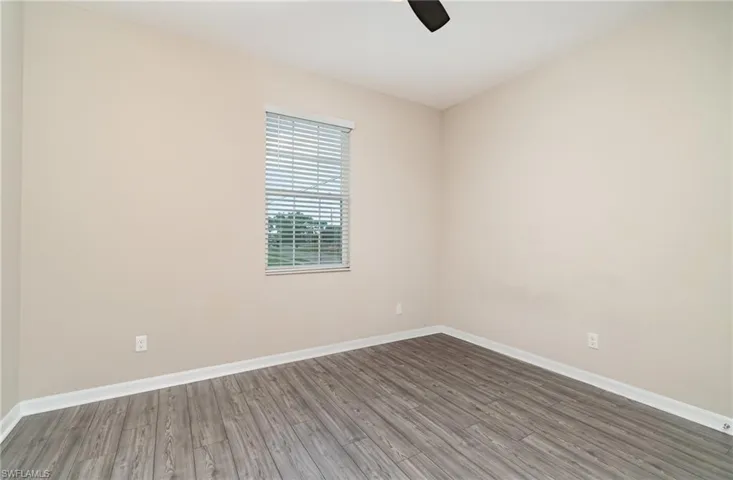 Empty room featuring wood finished floors and ceiling fan