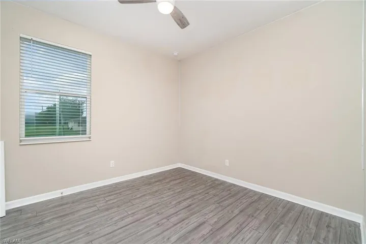Unfurnished room featuring wood finished floors and a ceiling fan