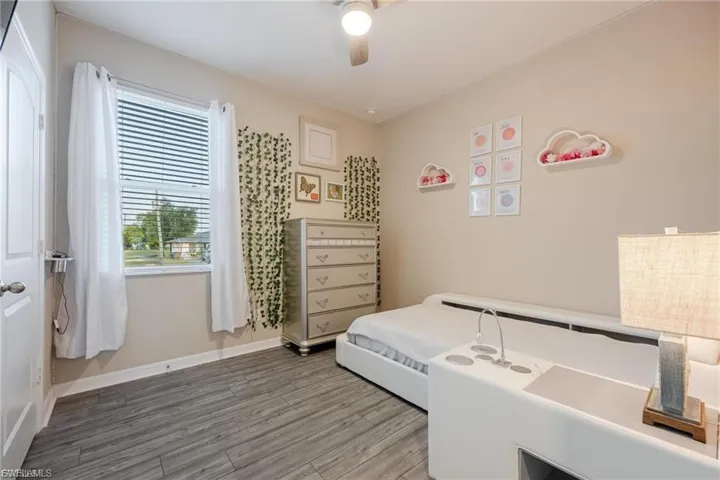 Unfurnished bedroom with wood finished floors and ceiling fan