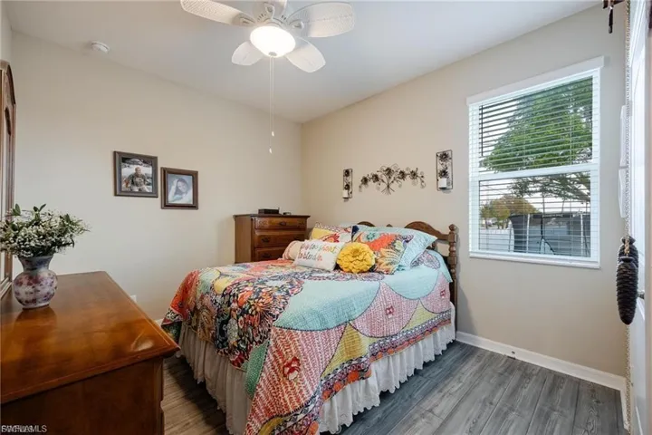 Unfurnished room featuring wood finished floors and a ceiling fan