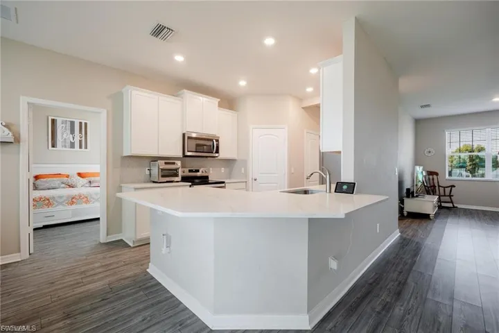 Unfurnished living room featuring ceiling fan, light wood-style flooring, and recessed lighting