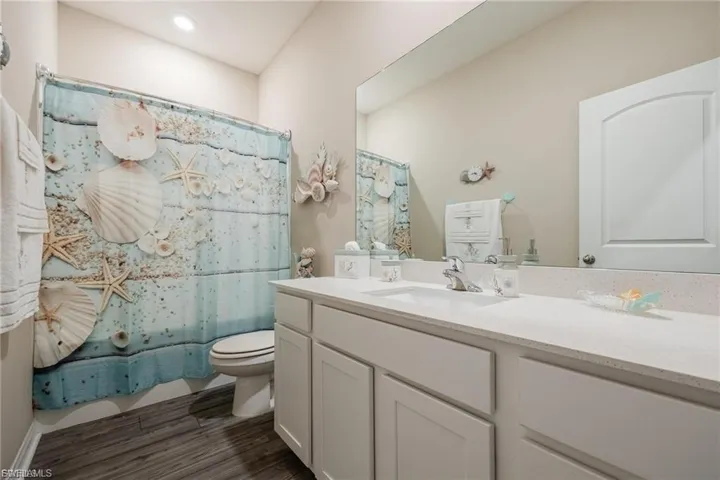 Spare room with wood finished floors and recessed lighting