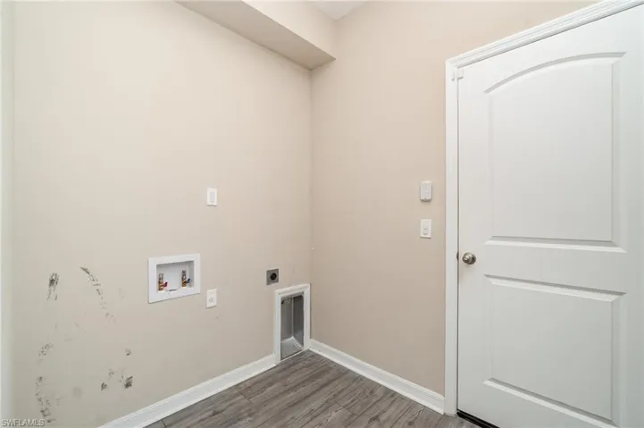 Washroom featuring washer hookup, electric dryer hookup, and wood finished floors