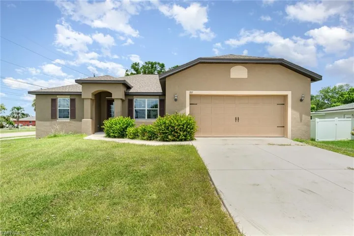 Ranch-style home featuring stucco siding, a garage, concrete driveway, and a shingled roof