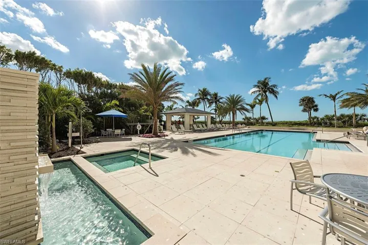 Community pool featuring a gazebo, a patio, and a hot tub