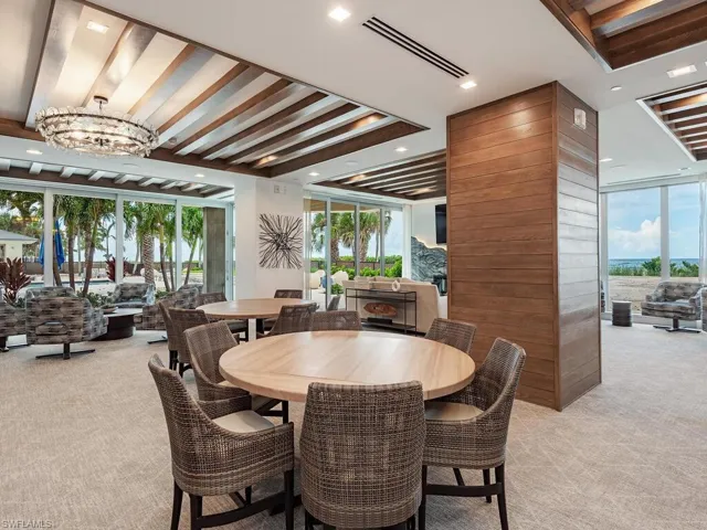 Dining room featuring light colored carpet, recessed lighting, and a chandelier