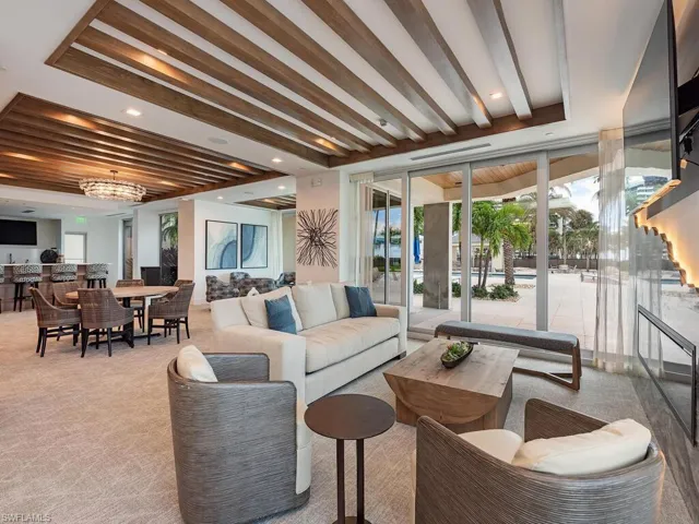 Party room with seating area by the firplace overlooking the pool.