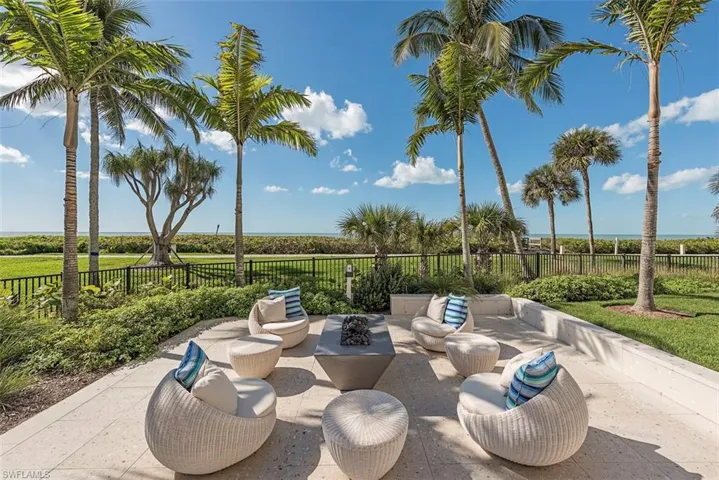 Beach front patio and an outdoor living space with a fire pit