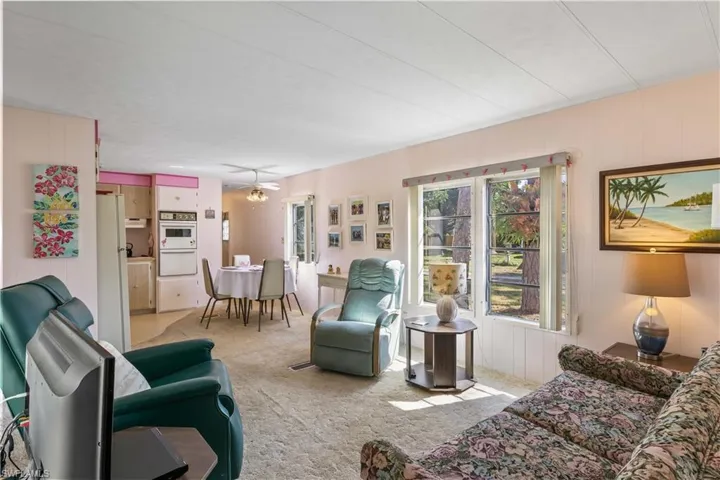 Spacious living room with double windows - airy and bright and open to the kitchen and dining area!