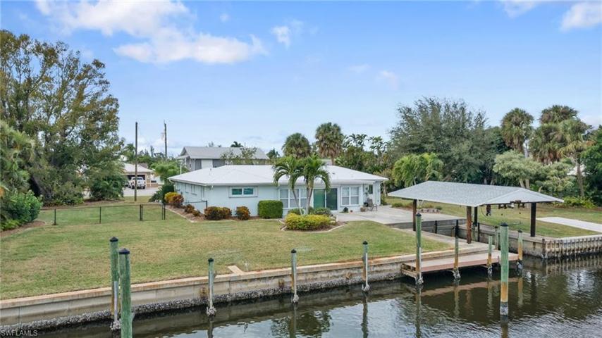Stunning water frontage and RARELY seen covered boat house