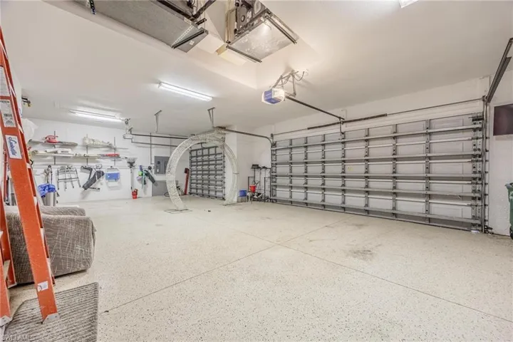 Garage featuring electric panel and a garage door opener