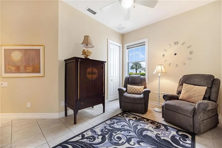 Sitting room featuring light tile patterned floors and ceiling fan