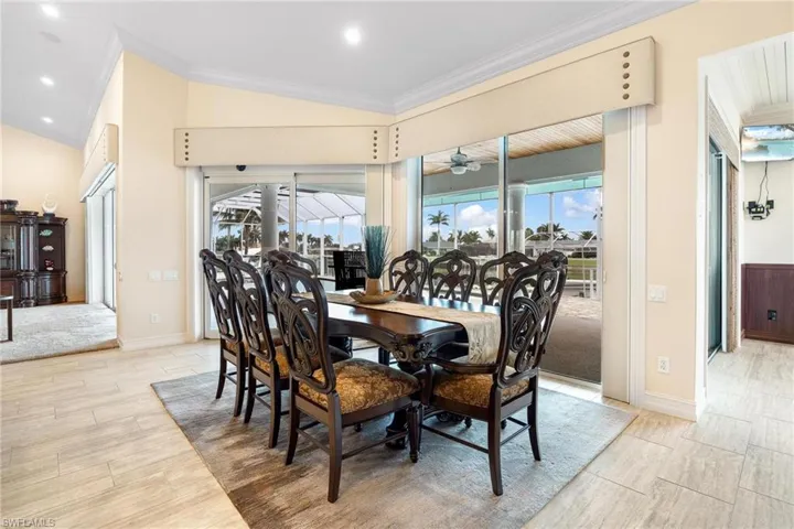 Dining room featuring crown molding, ceiling fan, and vaulted ceiling