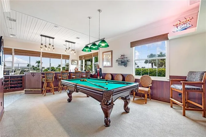 Rec room with indoor bar, crown molding, carpet flooring, and billiards