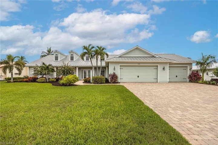Ranch-style home with a garage and a front lawn