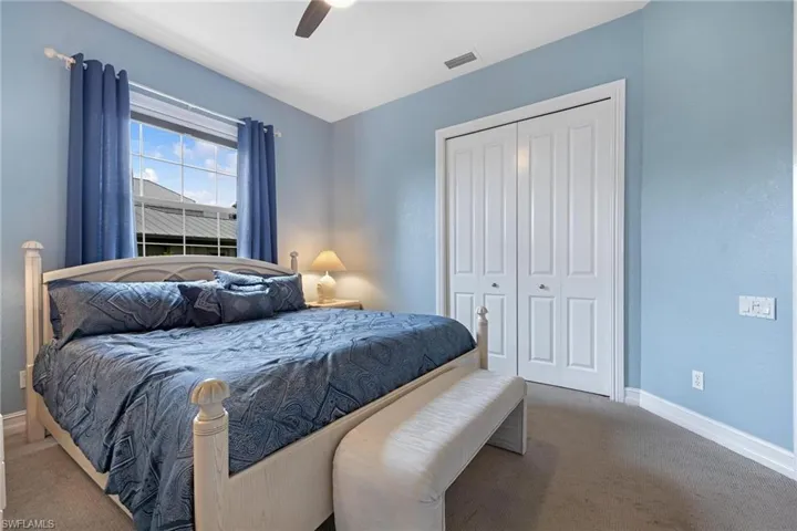Bedroom featuring ceiling fan, carpet flooring, and a closet