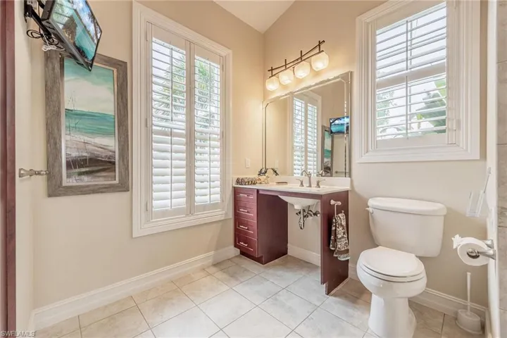 Bathroom with vanity, toilet, and tile patterned flooring