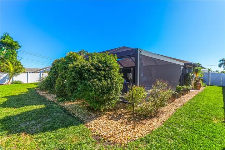 Back of property with a fenced backyard, screen enclosure