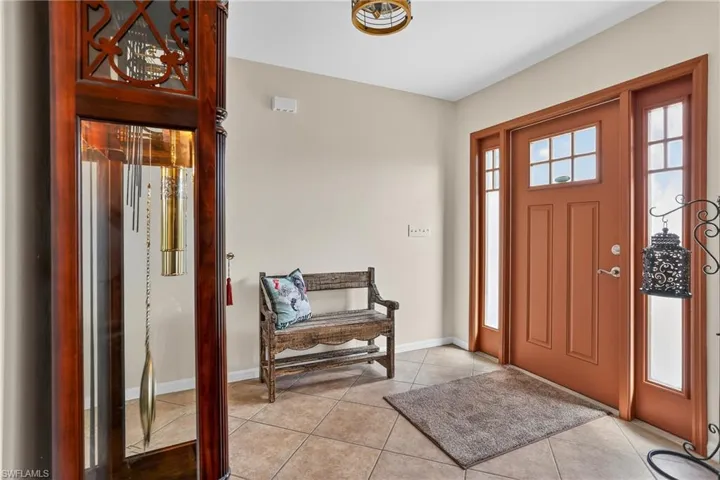 Entryway featuring baseboards and light tile patterned floors