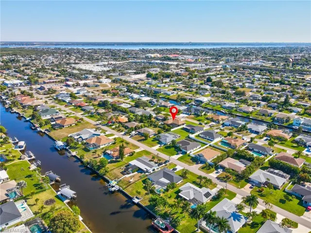 View of property location with a large body of water and nearby suburban area
