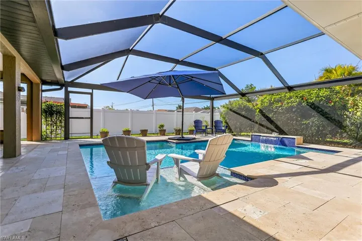 Pool with sun shelf and travertine deck!
