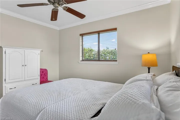 Bedroom with crown molding and ceiling fan