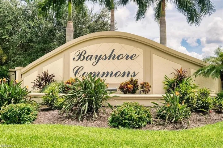 Welcome to Bayshore Commons, a gated community entrance featuring elegant signage and mature landscaping