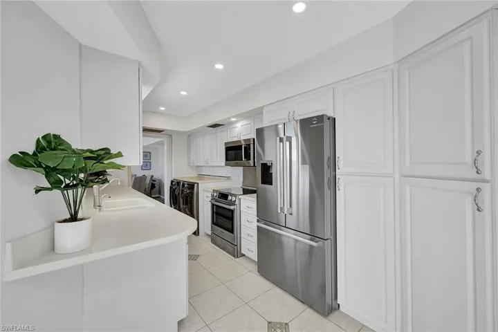 The kitchen offers a convenient desk overhang and modernized lighting