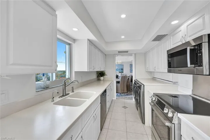 New stainless appliances in the kitchen with a window overlooking the bay