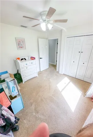 Rec room with carpet floors and ceiling fan