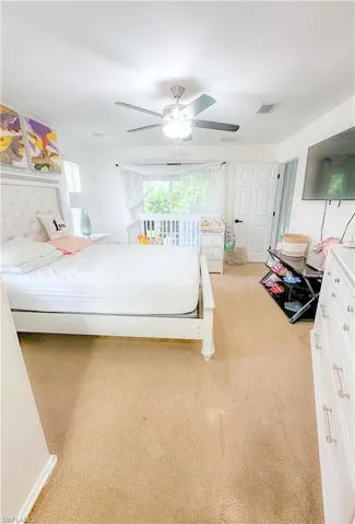 Carpeted bedroom with ceiling fan
