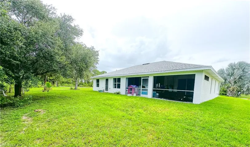 Rear view of house featuring a yard
