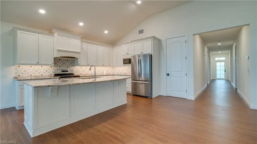 Kitchen with high-end stainless steel appliances and large kitchen island.