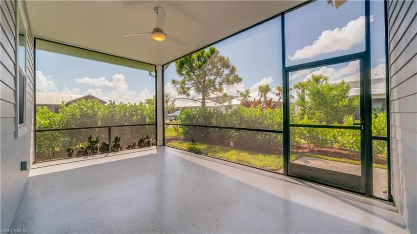 Rear screened lanai featuring ceiling fan.