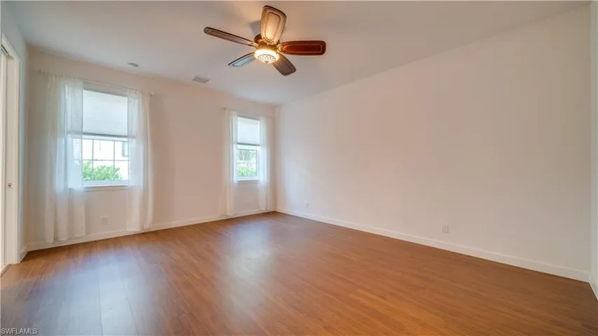 Primary bedroom with great natural light & ceiling fan.