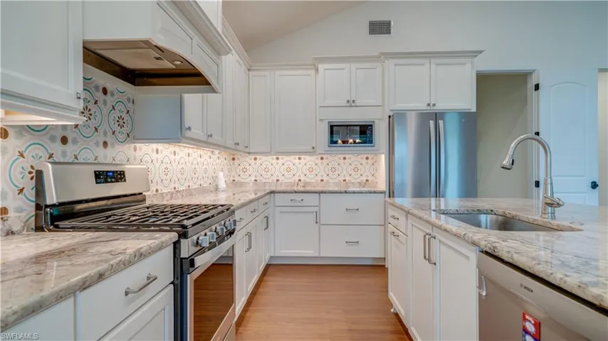 Gas stove, custom cabinetry, granite counters.