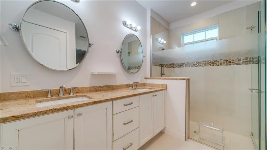 Primary Bathroom features double sinks, granite counters, walk-in all tiled shower, private toilet area, and an enormous walk-in closet.