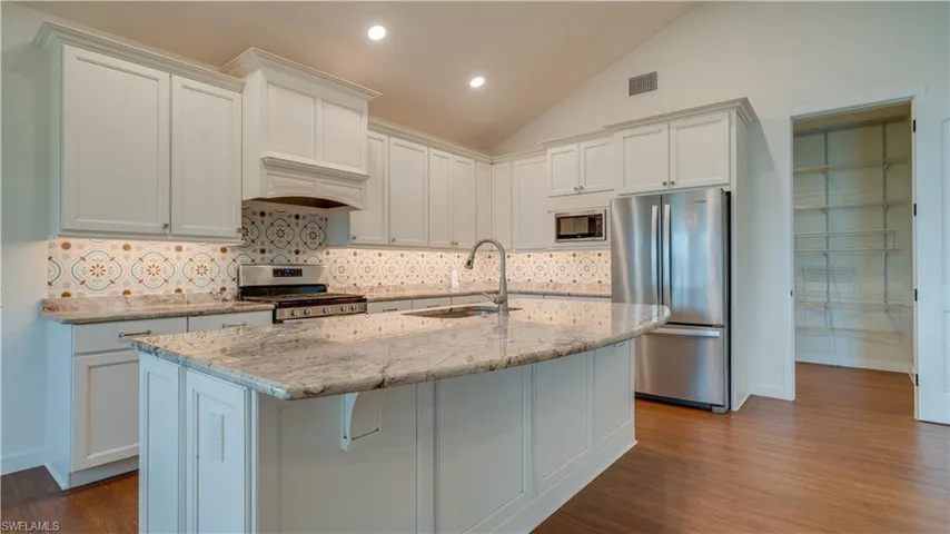 Kitchen showing entrance to walk-in pantry.