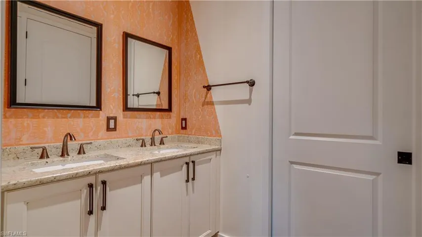 Guest bathroom features double sinks & granite counters.
