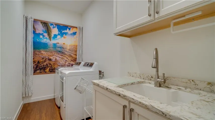 Oversized laundry room with sink & cabinet storage. Room to add much more.