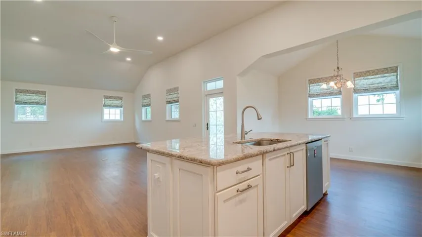 Another view of the dining alcove & the back side of the island .