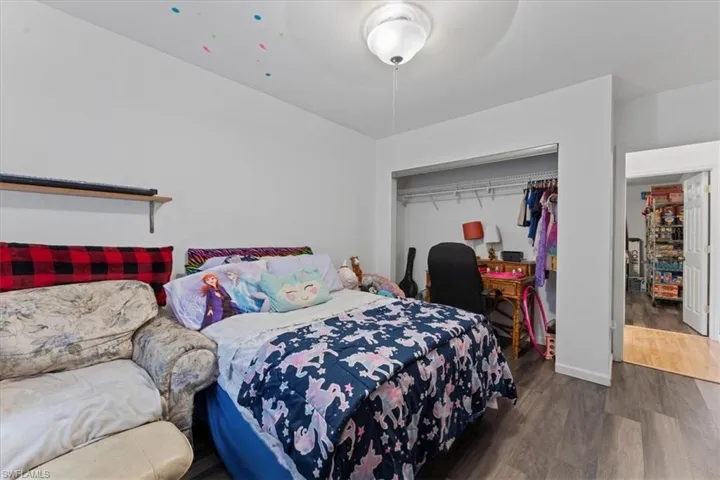 Bedroom with a closet and wood finished floors