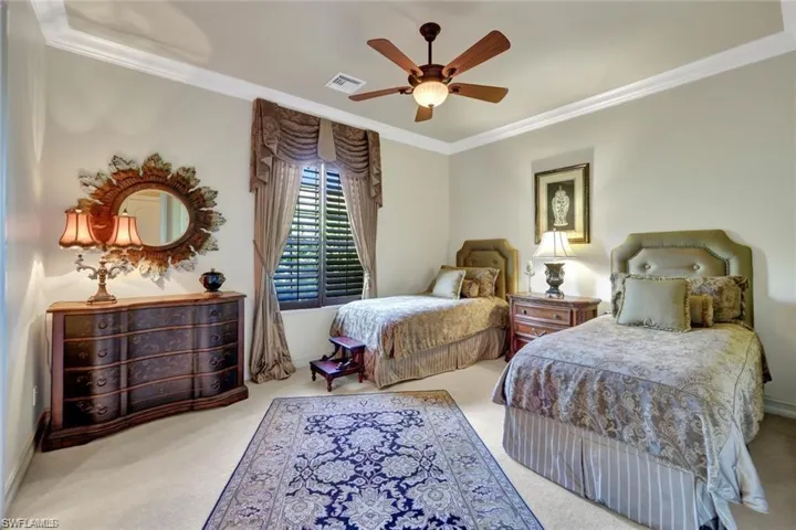 Bedroom featuring carpet flooring, ceiling fan, and ornamental molding
