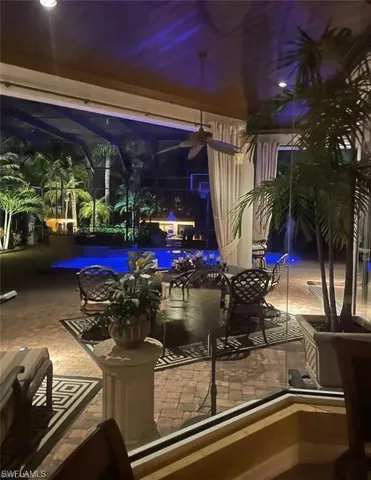 View of patio / terrace with a lanai and a swimming pool