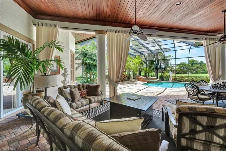 Sunroom / solarium with ceiling fan and a swimming pool