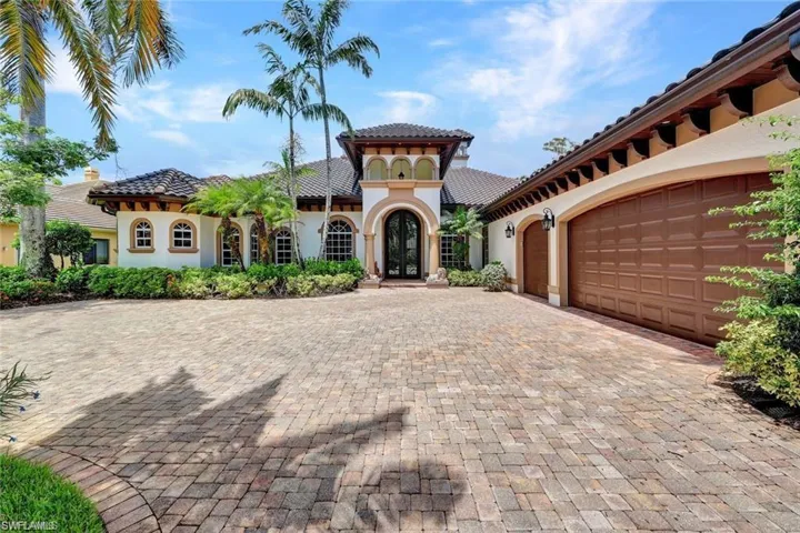 Mediterranean / spanish home with french doors and a garage