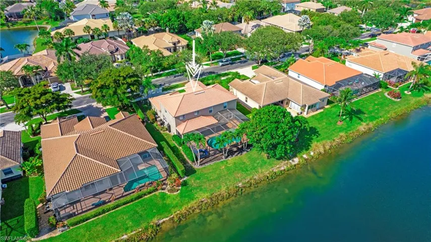 Aerial perspective of suburban area featuring a nearby body of water