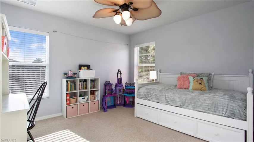 Bedroom featuring light carpet and ceiling fan